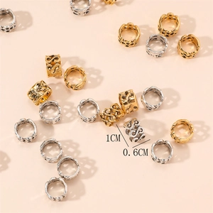 Detail of vintage hollow pattern braid rings in gold and silver, size 1cm x 0.6cm
