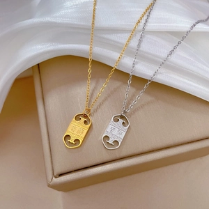 Detail of gold and silver rectangular pendant necklaces with hollow cloud patterns