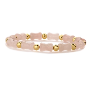 Chic beaded bamboo style bracelet with pink stones and gold spacers on white backdrop