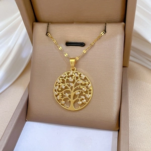 Macro detail of Tree of Life pendant with sparkling crystals in a champagne gift box