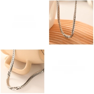 Detailed close-up showing the polished silver curb chain links and refined craftsmanship