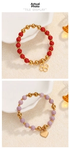 Detail of beaded stretch bracelets with clover and heart pendants on white texture