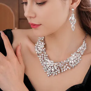 Elegant silver flower jewelry set with sparkling crystals on female model for wedding