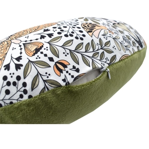 Detailed close-up of a nursing pillow cover showing soft green velvet fabric and a zipper