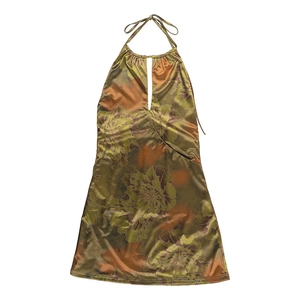 Detail of floral halter mini dress showing glossy green and orange satin fabric texture