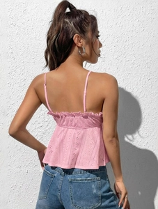 Detail of pink lace sleeveless top showing back embroidery and hollow-out design
