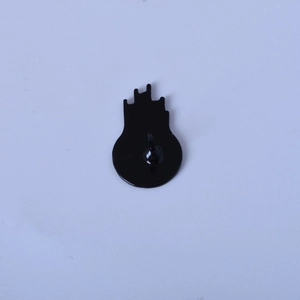 Detailed back view of a black enamel pin showing the alloy base and securing needle