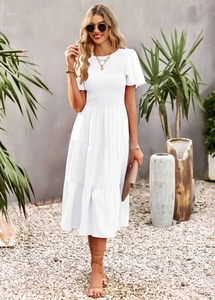 Detailed view of the white shirred bodice and layered ruffle hem on the midi dress