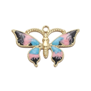 Detailed macro view of a colorful butterfly pendant with marble enamel and gold base