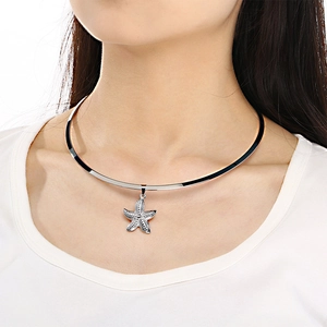 Polished stainless steel rigid neckwire featuring a textured starfish pendant on model