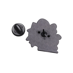 Detail of metal pin back with black rubber clutch and honeycomb textured finish