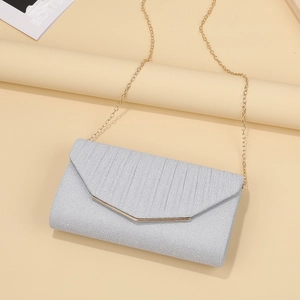 Elegant silver glitter evening clutch bag with gold chain strap and V-shaped metal trim