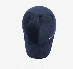 Top view of navy blue corduroy baseball cap with metal logo detail and reinforced brim