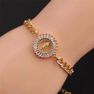 Detail of gold Cuban chain bracelet with Virgin Mary medallion and zircon inlays