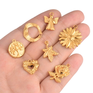 7-piece set of gold stainless steel charms featuring angel, sunflower and leaf shapes