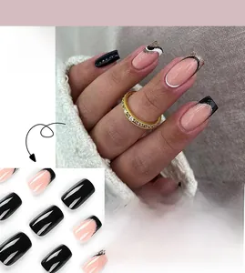 Detail of French press-on nails featuring black and pink tips with golden glitter waves