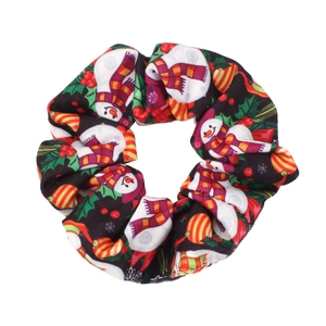 Detail of Christmas scrunchie featuring festive snowman and berry prints on black fabric