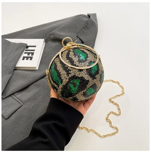 Close-up of a leopard print sequin sphere evening bag with a gold metal ring handle