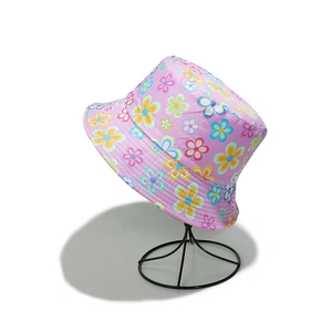 Detail of pink summer bucket hat featuring vibrant floral patterns on durable canvas fabric