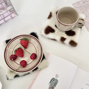 Plush heart-shaped square coasters in cow print pattern for cozy home table decor