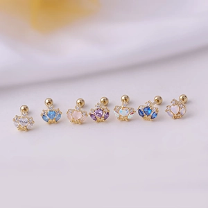 Set of seven titanium steel crown earrings with colorful zircon stones on white fabric