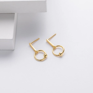 Detail view of gold geometric dangle earrings with sleek vertical bars and bead rings