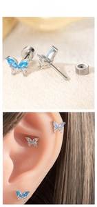 Detailed view of titanium steel butterfly labret studs with inlaid blue and white zircons
