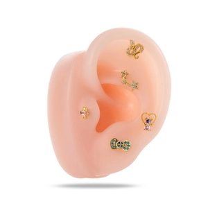 Gold stainless steel cartilage earrings set featuring stars, bear, and bow with crystals