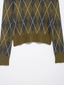 Close-up of argyle knit polo sweater featuring olive green and grey diamond pattern