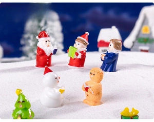 Miniature Christmas choir figurines set on a snowy surface for DIY festive micro landscapes