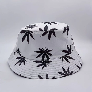 Detail shot of white bucket hat with black leaf print pattern and premium fabric texture