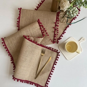 Jute table runner and placemat set with red pom-pom trim for festive home dining decor