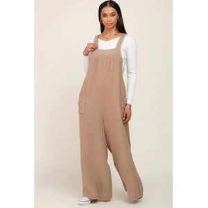 Detail of loose beige maternity wide leg jumpsuit featuring side pockets and linen texture