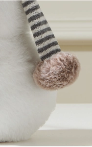 Macro detail of plush faux fur texture and striped knitted fabric on gnome decor