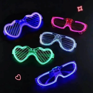 Close-up of LED glowing shutter and heart shaped glasses in neon colors for parties