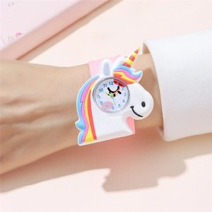 Detailed view of the pink silicone strap and 3D unicorn watch face on a child's wrist