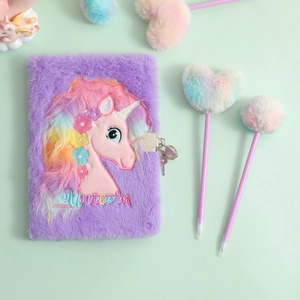 Detailed view of purple plush unicorn diary with lock and matching pom-pom heart pens