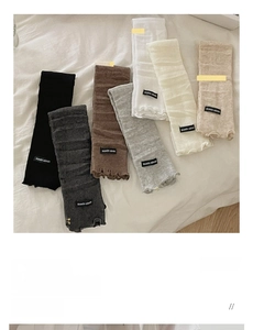 Detailed knit texture and ruffle edge of thin summer leg warmers in various colors