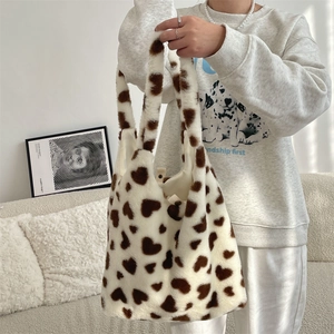 Close-up of fluffy tote bag with heart patterns and magnetic snap closure detail