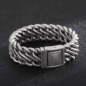 Macro detail of vintage silver stainless steel curb chain bracelet with square clasp