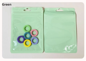 Colorful plastic rings in frosted green matte resealable packaging bag with zipper seal