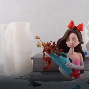 Detail of girl figurine silicone mold showing raw mold and finished resin flower pot art