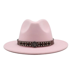 Detail of pink wool fedora hat featuring brown leather band with silver studs and metal buckle
