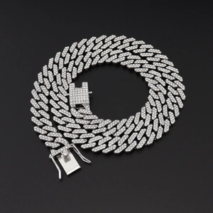 Detail of silver iced-out Cuban link chain with sparkling pavé rhinestones and square clasp