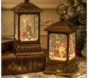 Close-up of bronze vintage Christmas lanterns with Santa and tree miniature scenes