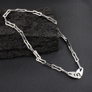 Industrial style silver titanium steel chain necklace with large lobster clasp on rock