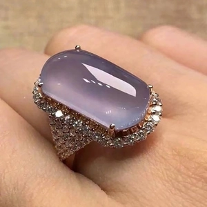 Close-up of a luxury rectangular purple gemstone ring in rose gold with pave zircons