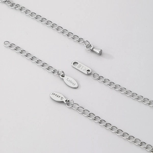 Three silver stainless steel 18K gold extension chains with engraved metal tags