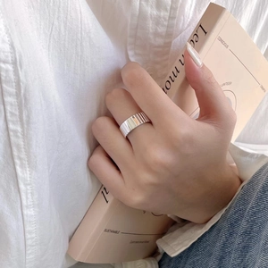 Close-up of a 925 silver wide ribbed band ring worn casually on the index finger
