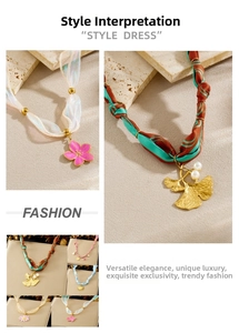 Detail of floral ribbon necklace with gold ginkgo leaf and enamel flower pendants